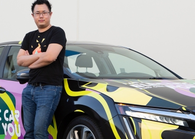 Kelvin Liu standing next to his newly wrapped plug-in hybrid Honda Clarity