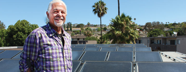 William Lamden in front of solar water heating panels