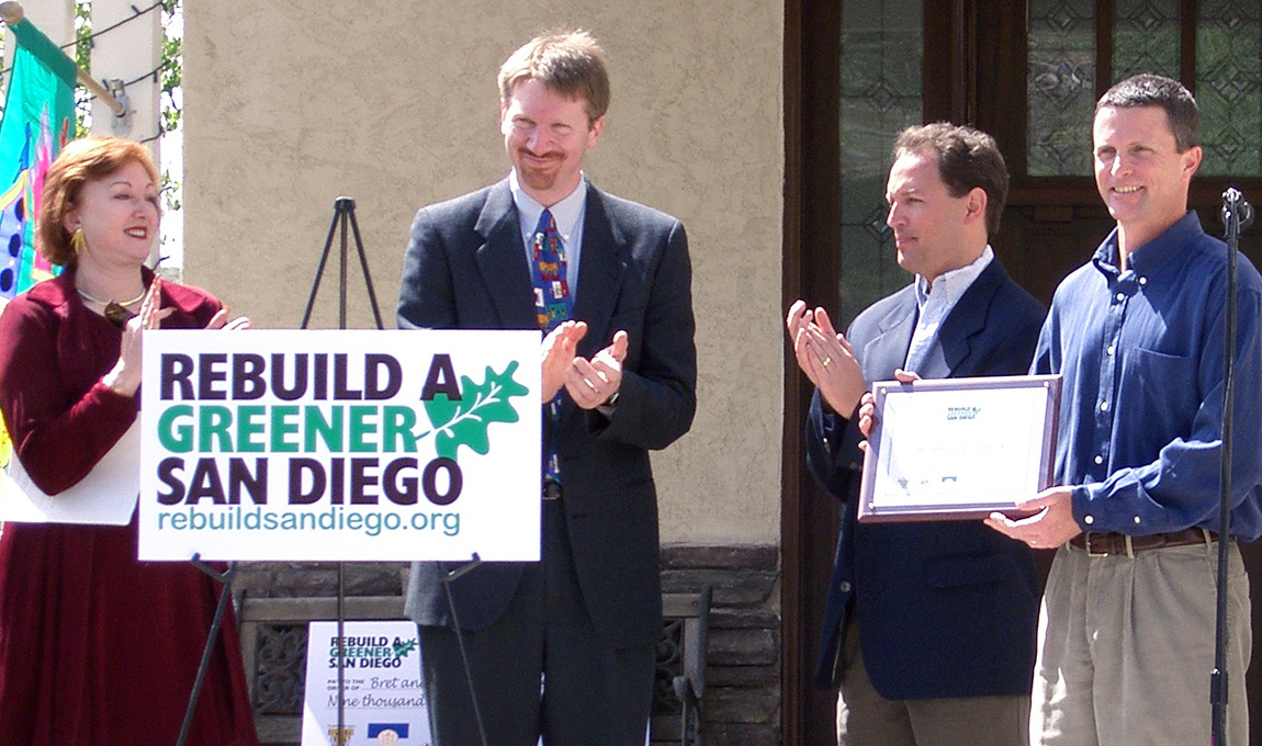 group receiving recognition with next to a Reuild a Greener San Diego sign