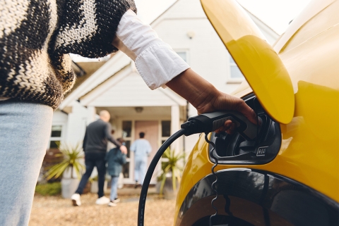 Image of person plugging in EV