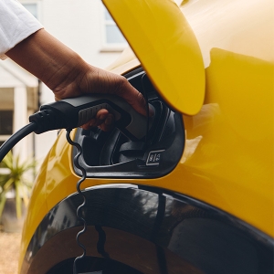 Image of person plugging in EV