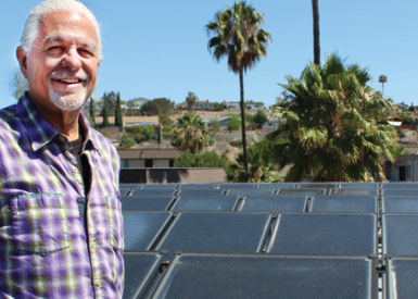 William Lamden in front of solar water heating panels