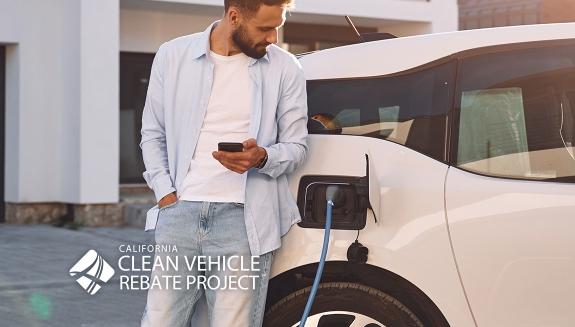 Image of man charging electric vehicle